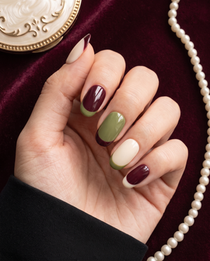 Burgundy, olive green, and cream French tip press-on nails with a glossy finish