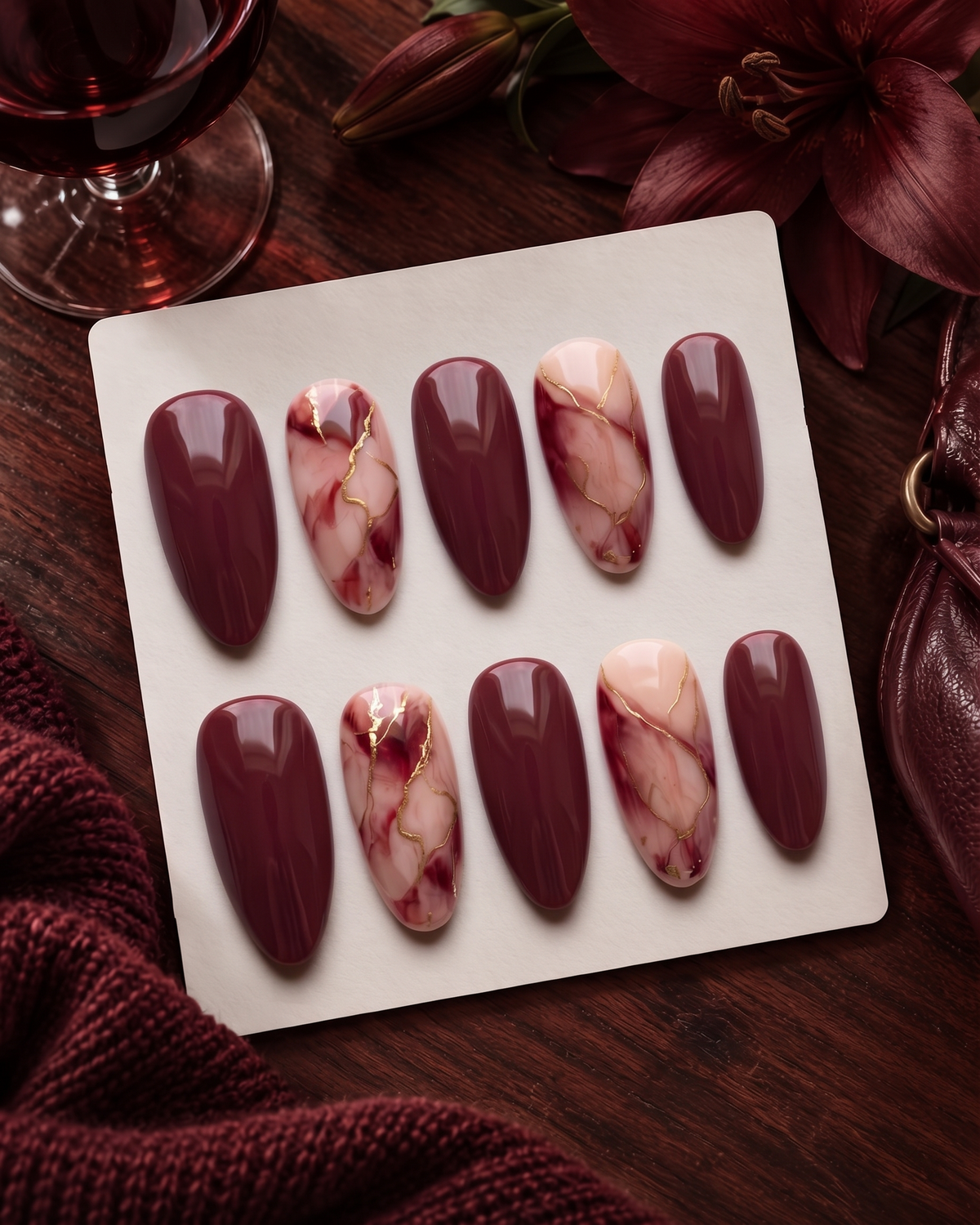 Burgundy and pink marble press-on nails with fine gold vein details