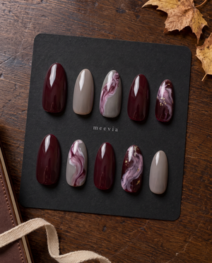 Burgundy and taupe glossy marble press-on nails with mauve swirls and gold flecks