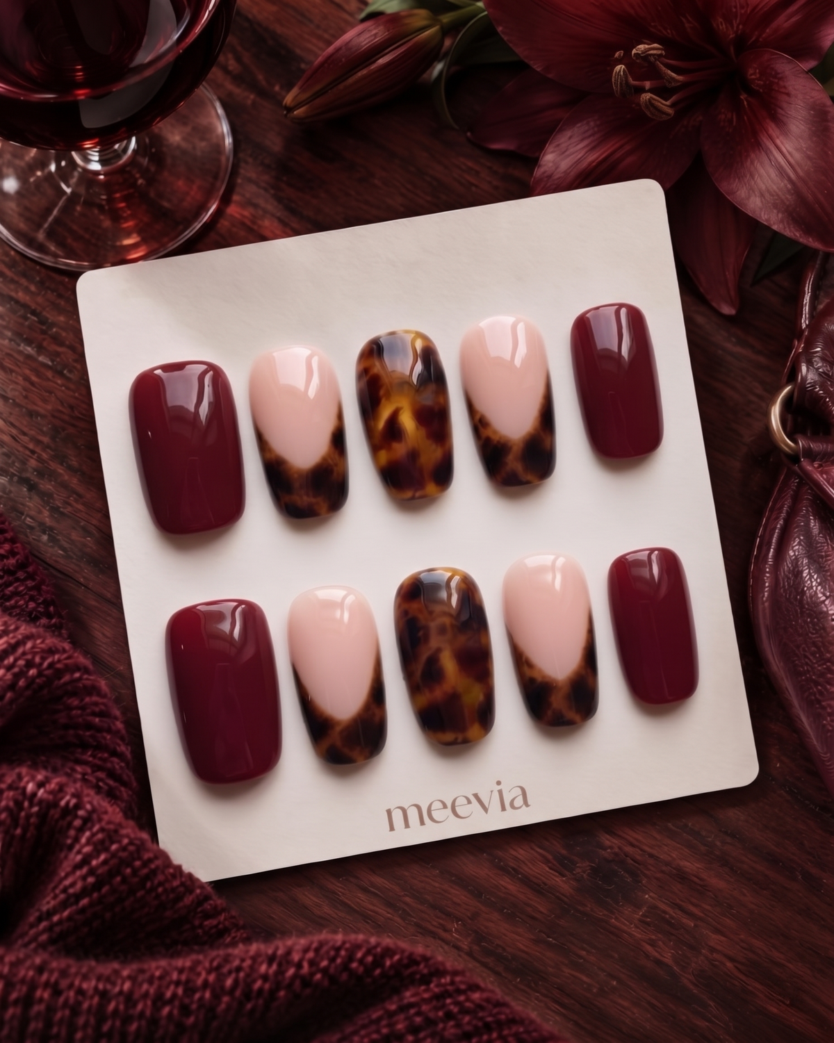 Burgundy and tortoiseshell French tip press-on nails with glossy finish