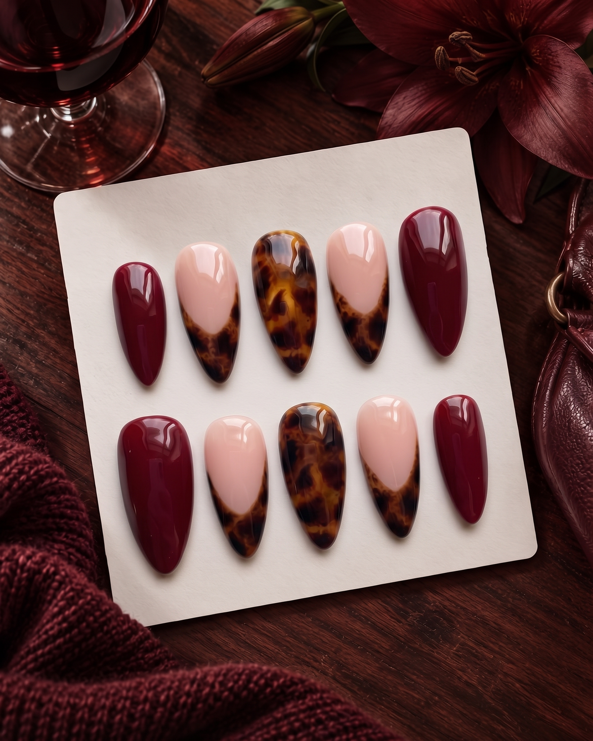 Burgundy and tortoiseshell French tip press-on nails with glossy finish