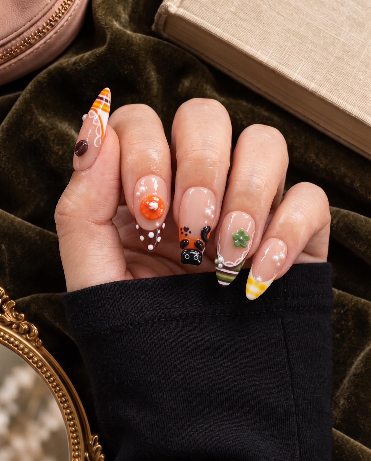 Glossy pink press-on nails with cat, dessert, flower, pearl, and gingham motifs