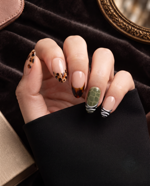 Glossy nude press-on nails with mixed tortoiseshell, olive, and zebra print French tips