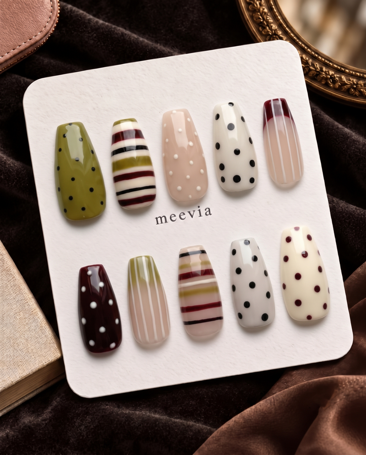 Mixed-pattern neutral press-on nails with olive, cream, nude, burgundy, black stripes and polka dots