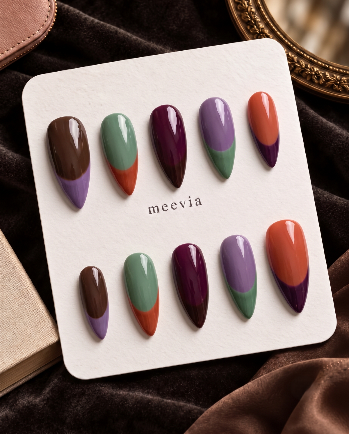 Multicolor glossy French tip press-on nails in brown, lavender, sage green, plum, and orange