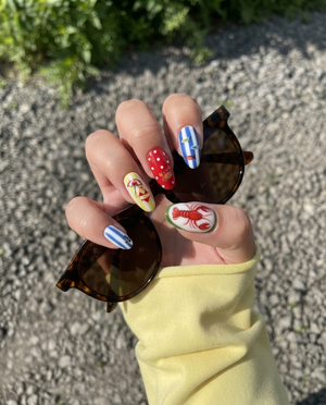 Nautical summer beach press-on nails featuring red lobster, crab, starfish, and 3D cherry designs.