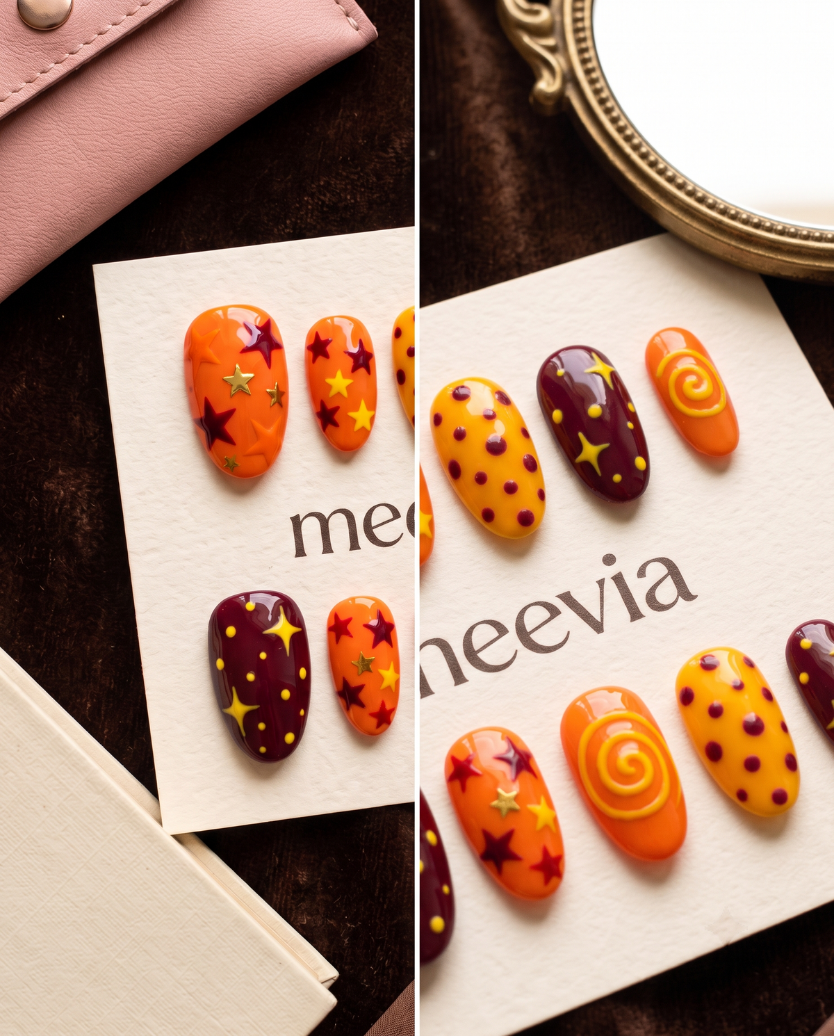 Orange and maroon celestial press-on nails with stars, dots, and swirl designs