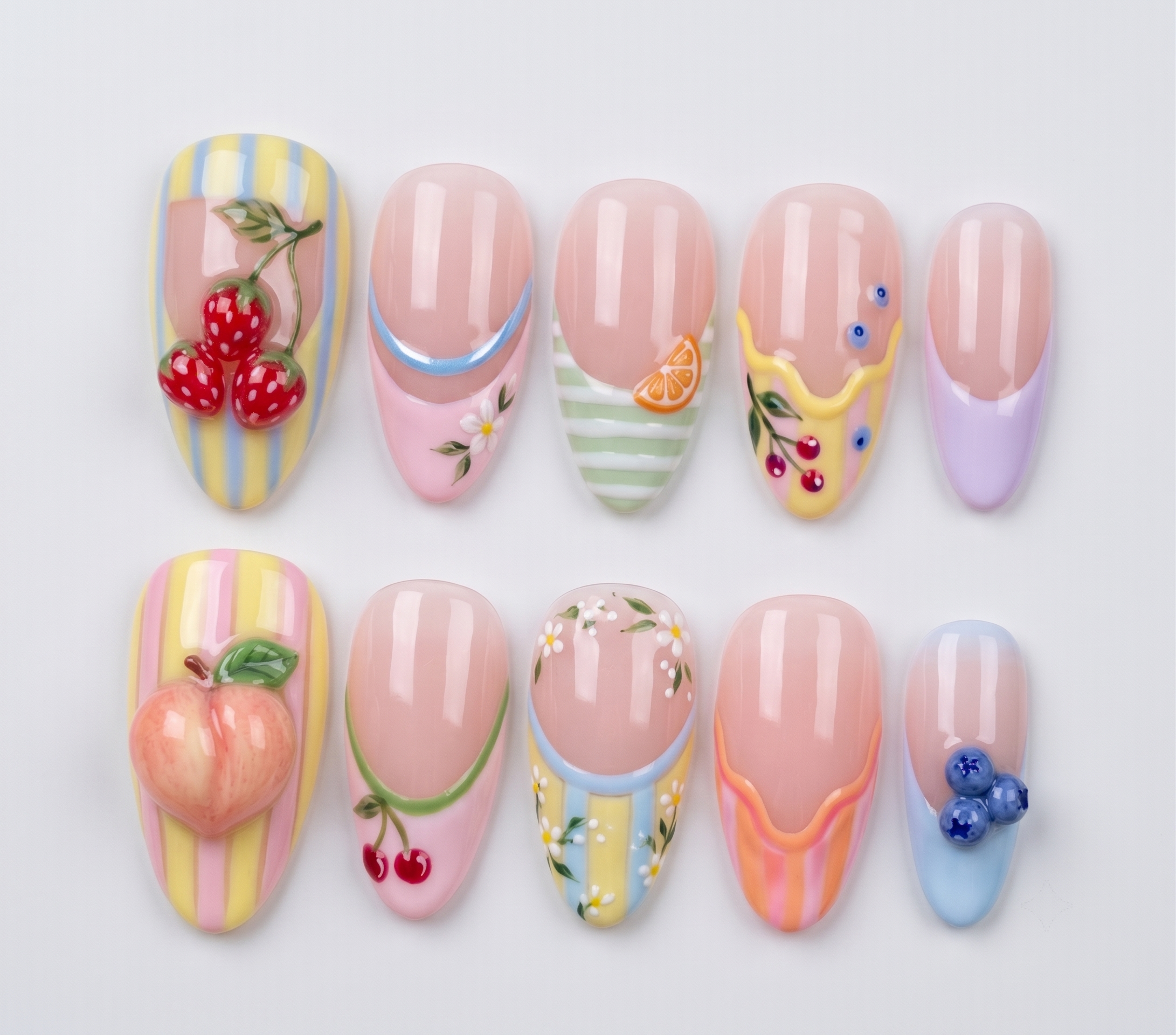 Pastel French tip press-on nails featuring 3d strawberries, blueberries, orange slices, and small daisy designs.