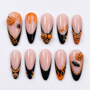 Halloween themed press-on nails with black French tips, 3D pumpkins, bat charms, flames, and spider web designs.