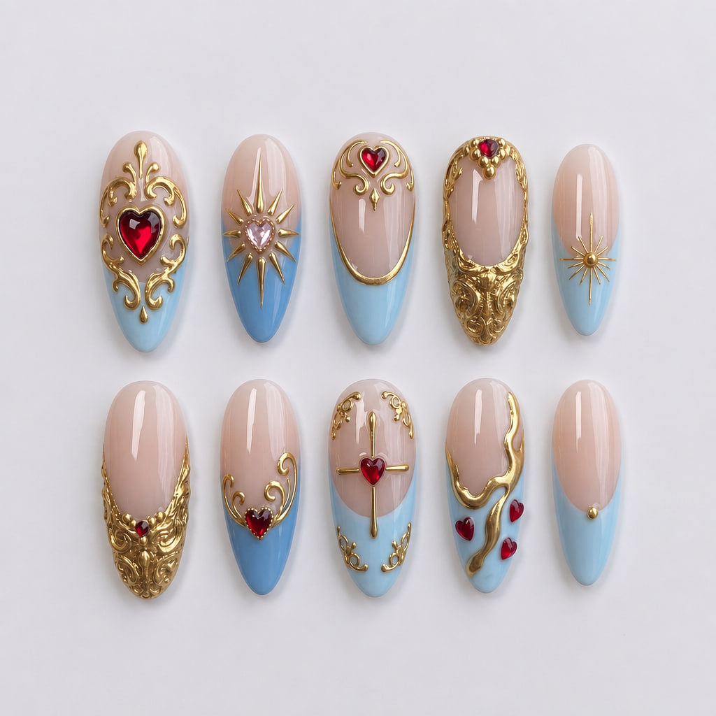 A set of press-on nails featuring light blue French tips, ornate gold baroque filigree, and red heart gems.