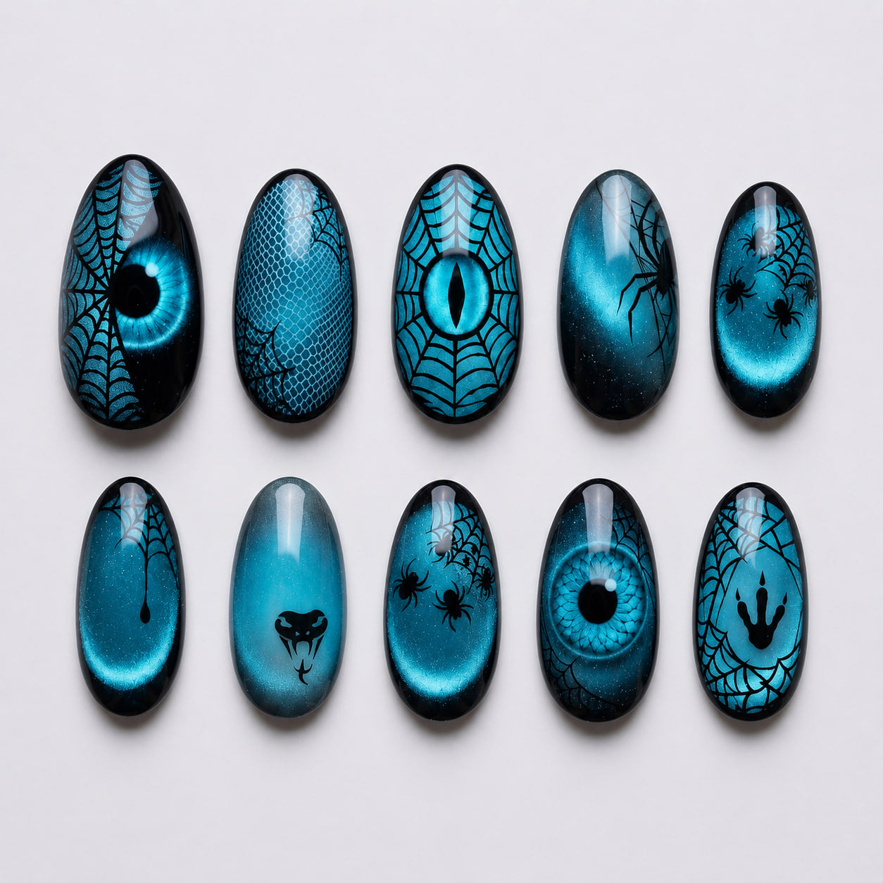 Teal cat-eye press-on nails with black spiderwebs, spiders, snake motif, claw marks, and reptile eye designs.