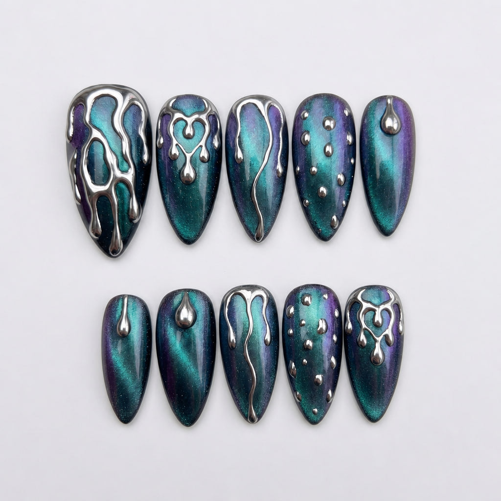 Set of press-on nails featuring teal and purple cat-eye polish with silver 3D chrome drip and droplet designs.