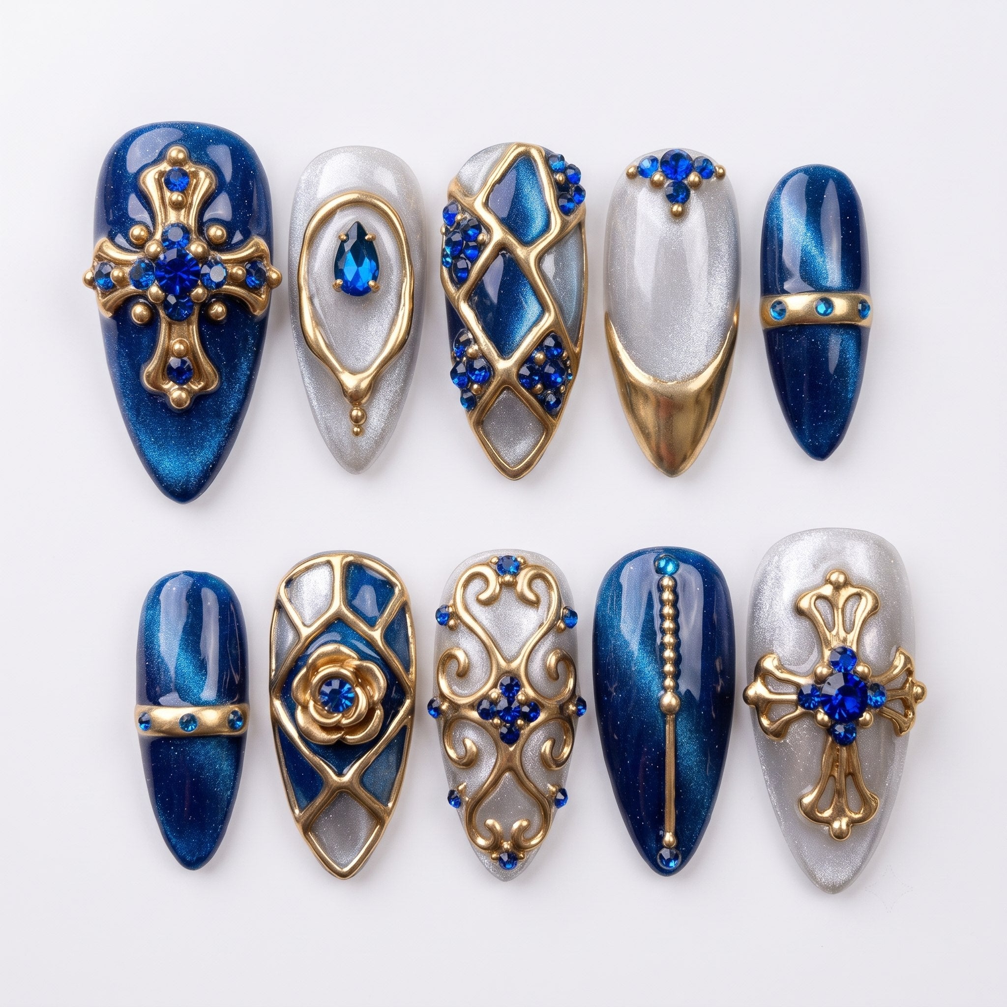 Royal blue and silver glitter press-on nails decorated with gold gothic crosses, baroque filigree, and blue rhinestones.