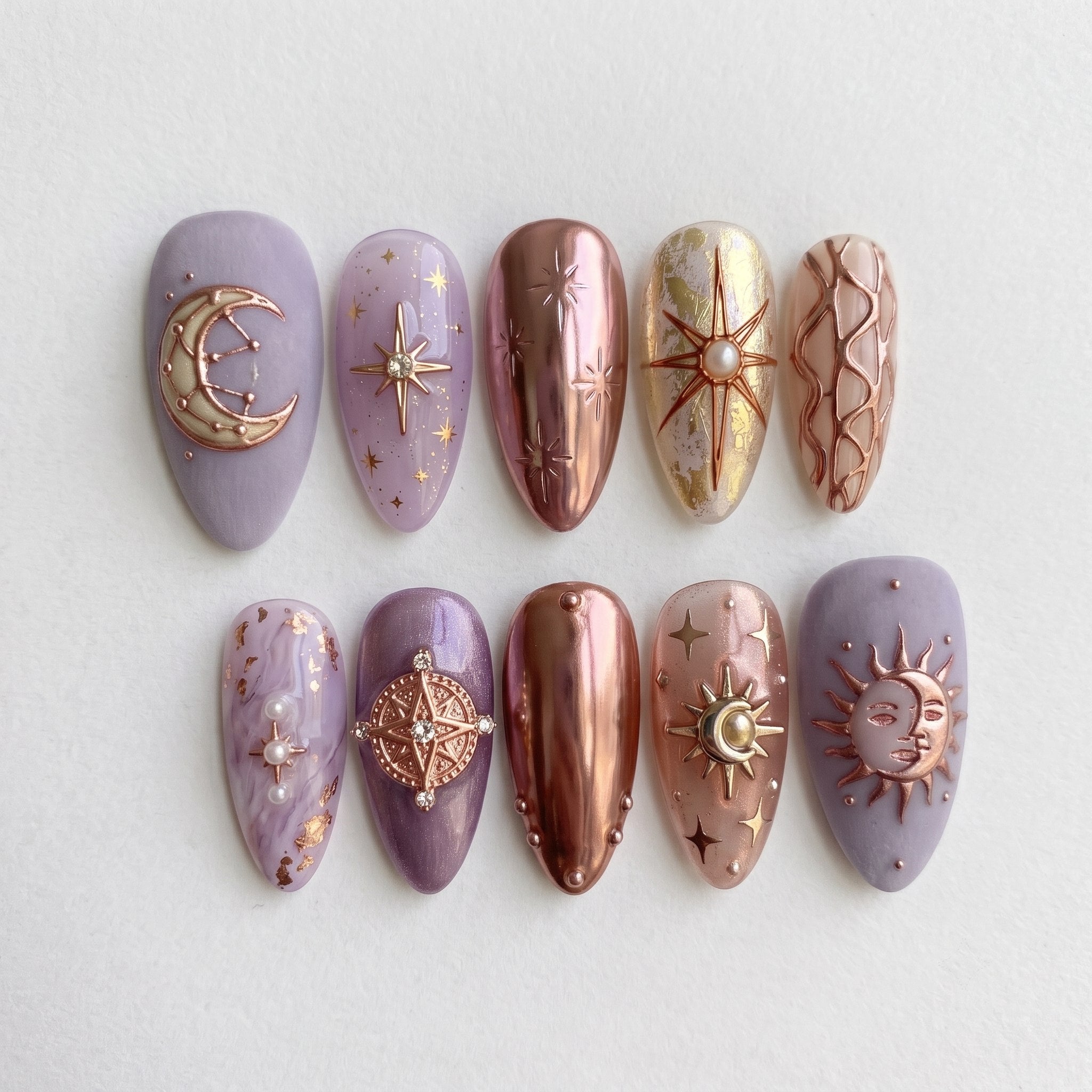 A set of celestial-themed press-on nails featuring lavender matte, rose gold chrome, and 3D star and moon charms.