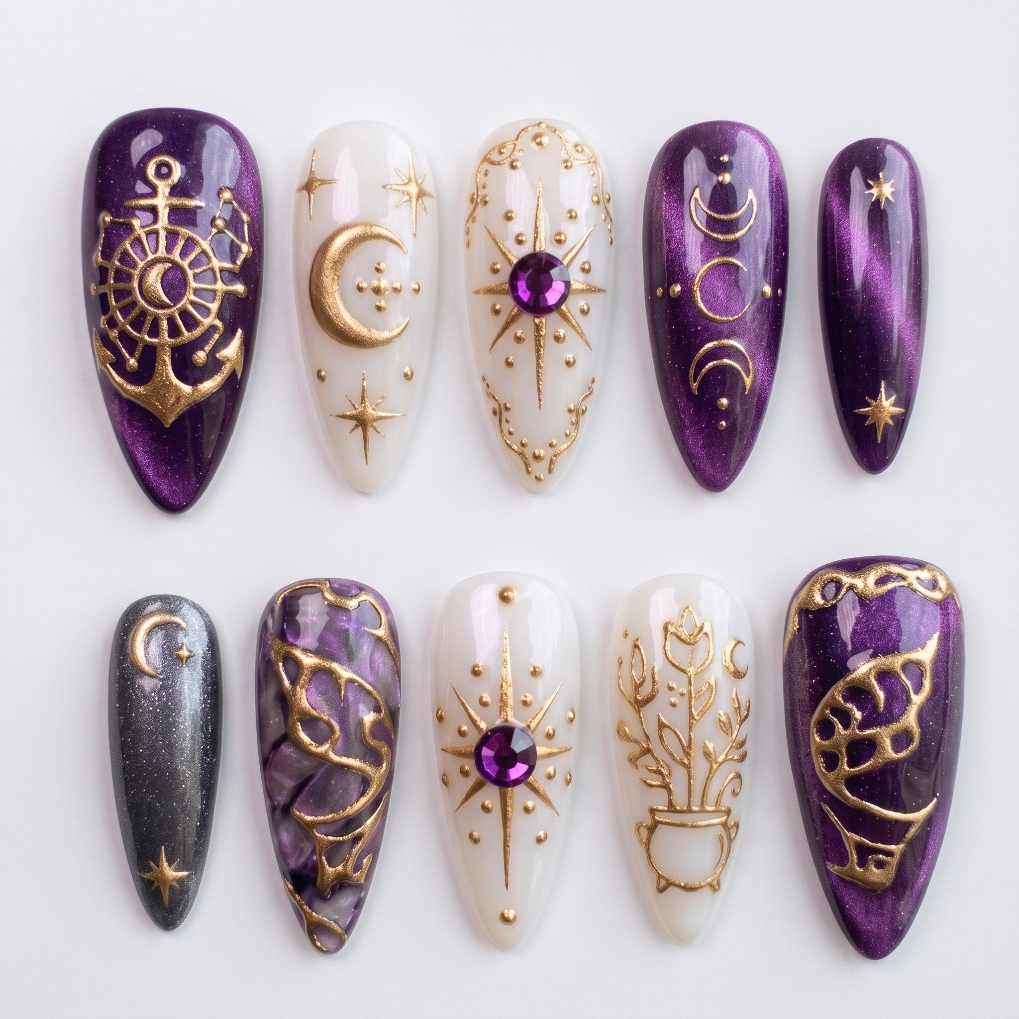 Set of celestial themed press-on nails in purple and white with gold moon and star accents.