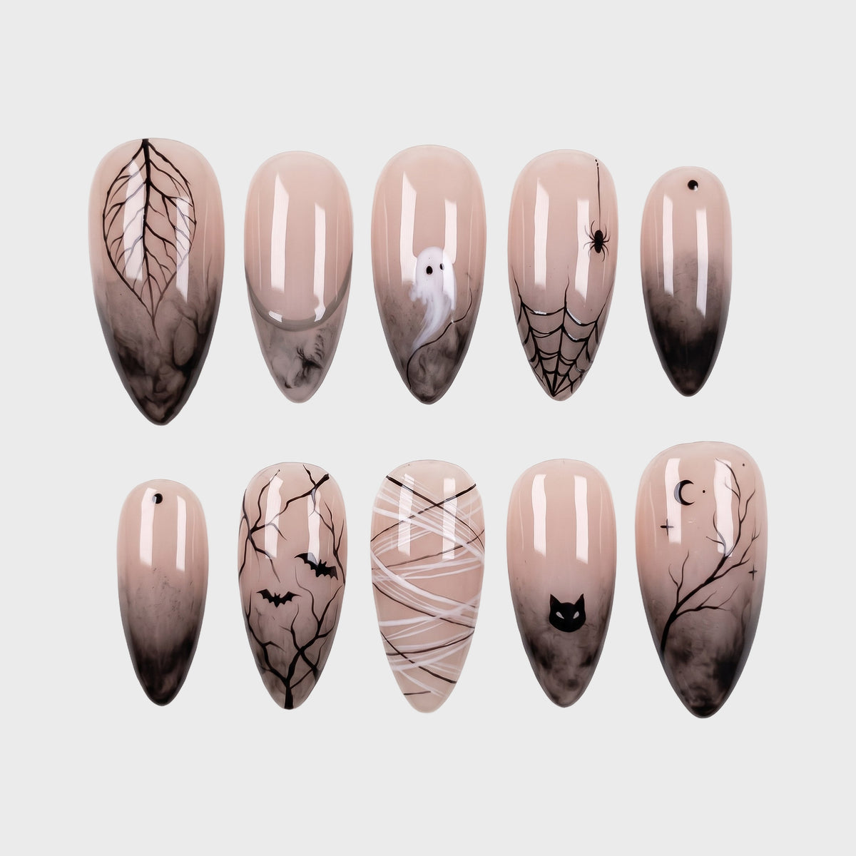 A set of spooky Halloween-themed press-on nails featuring black smoke gradients, ghosts, spider webs, and bats on a nude base.
