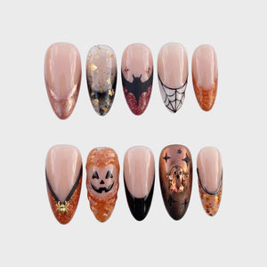 A set of Halloween-themed press-on nails featuring jack-o'-lanterns, ghosts, bats, and spiderwebs.