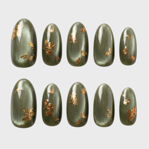 A set of almond-shaped olive green cat eye press-on nails decorated with gold foil flakes.