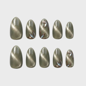 Olive green cat eye press-on nails with metallic leaf motifs.