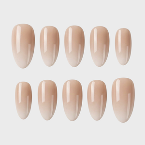 A set of nude ombre press-on nails with a glossy finish and almond shape.