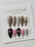 Stiletto-shaped gothic press-on nail set with chrome crosses and burgundy jelly finish