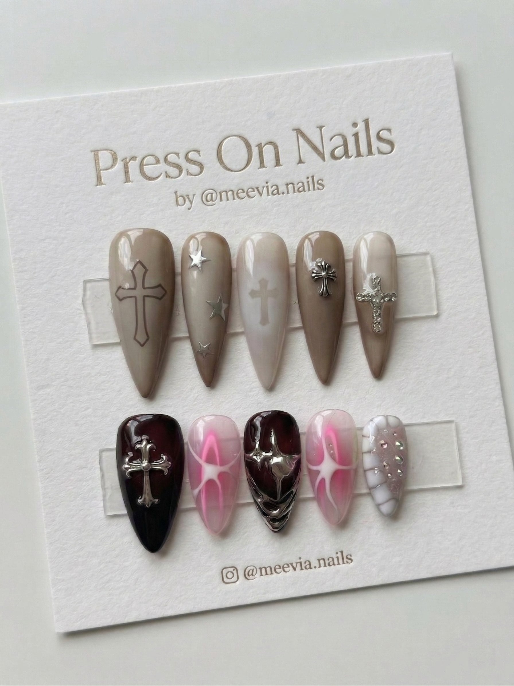 Stiletto-shaped gothic press-on nail set with chrome crosses and burgundy jelly finish