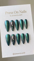 Stiletto-shaped green chrome press-on nails with 3D metallic scorpion and geometric nail art