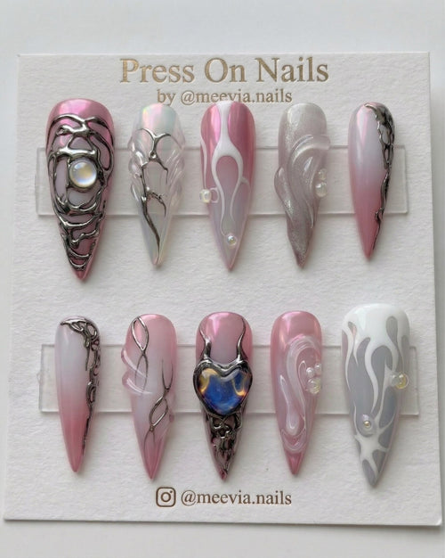 Long stiletto pink chrome press-on nails with 3D silver liquid metal art and iridescent heart charm.