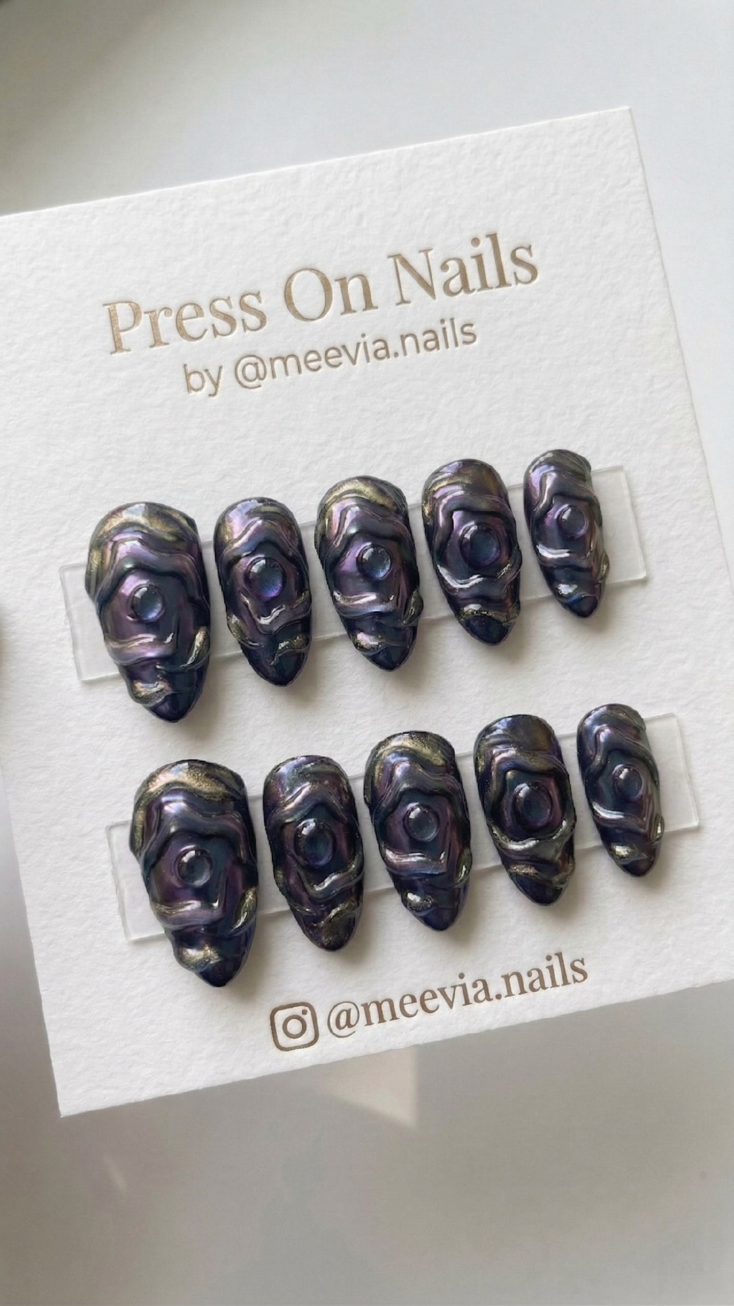 Almond-shaped 3D press-on nail set with purple galaxy shimmer and mystical eye designs