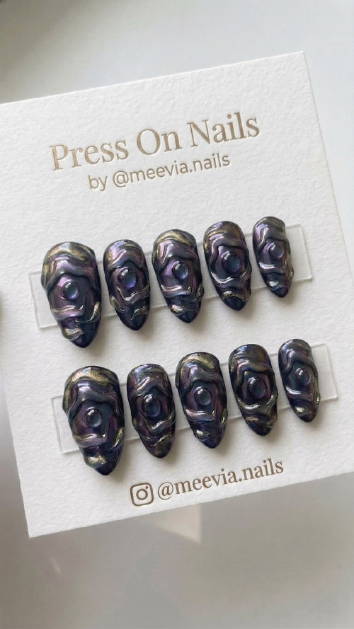 Almond-shaped 3D press-on nail set with purple galaxy shimmer and mystical eye designs