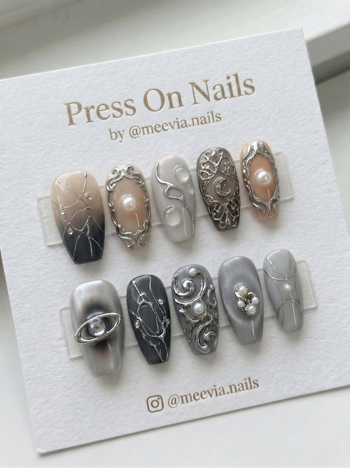 Long coffin-shaped grey press-on nail set with 3D silver filigree, pearls, and celestial moon motifs.