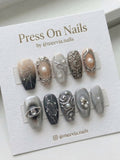 Coffin-shaped grey and silver press-on nail set with 3D gothic art, pearls, and celestial motifs