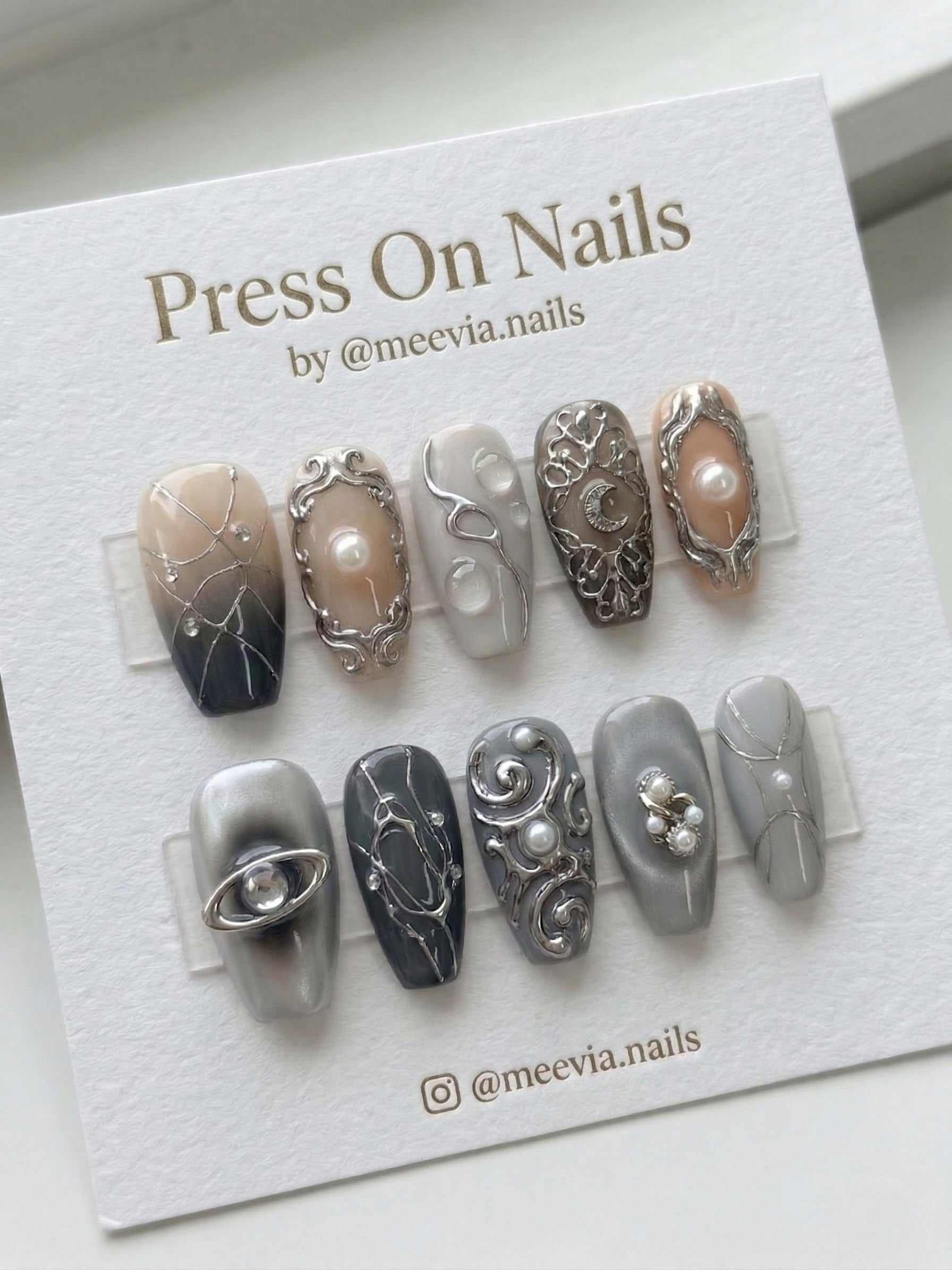 Coffin-shaped grey and silver press-on nail set with 3D gothic art, pearls, and celestial motifs