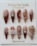 Stiletto-shaped red marble press-on nail set with 3D snakes and pearls