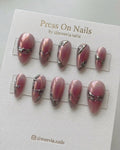 Almond-shaped pink chrome press-on nail set with silver 3D liquid metal accents