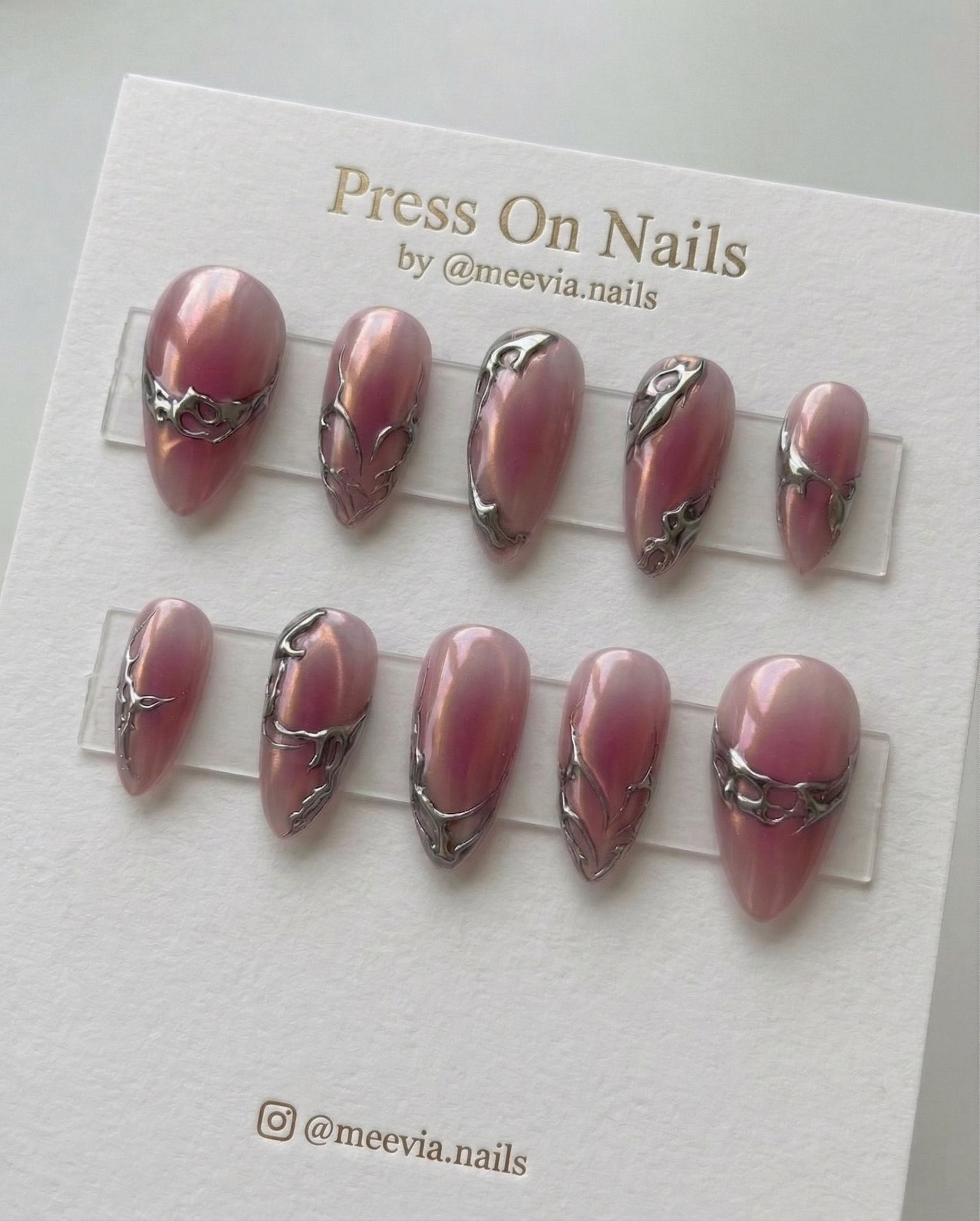 Almond-shaped pink chrome press-on nail set with silver 3D liquid metal accents