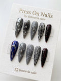 Stiletto-shaped gothic press-on nails with chrome 3D floral art and deep burgundy textures
