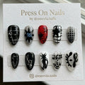 Stiletto-shaped 90s grunge press-on nail set with black stars, red accents, and 3D silver wire details.