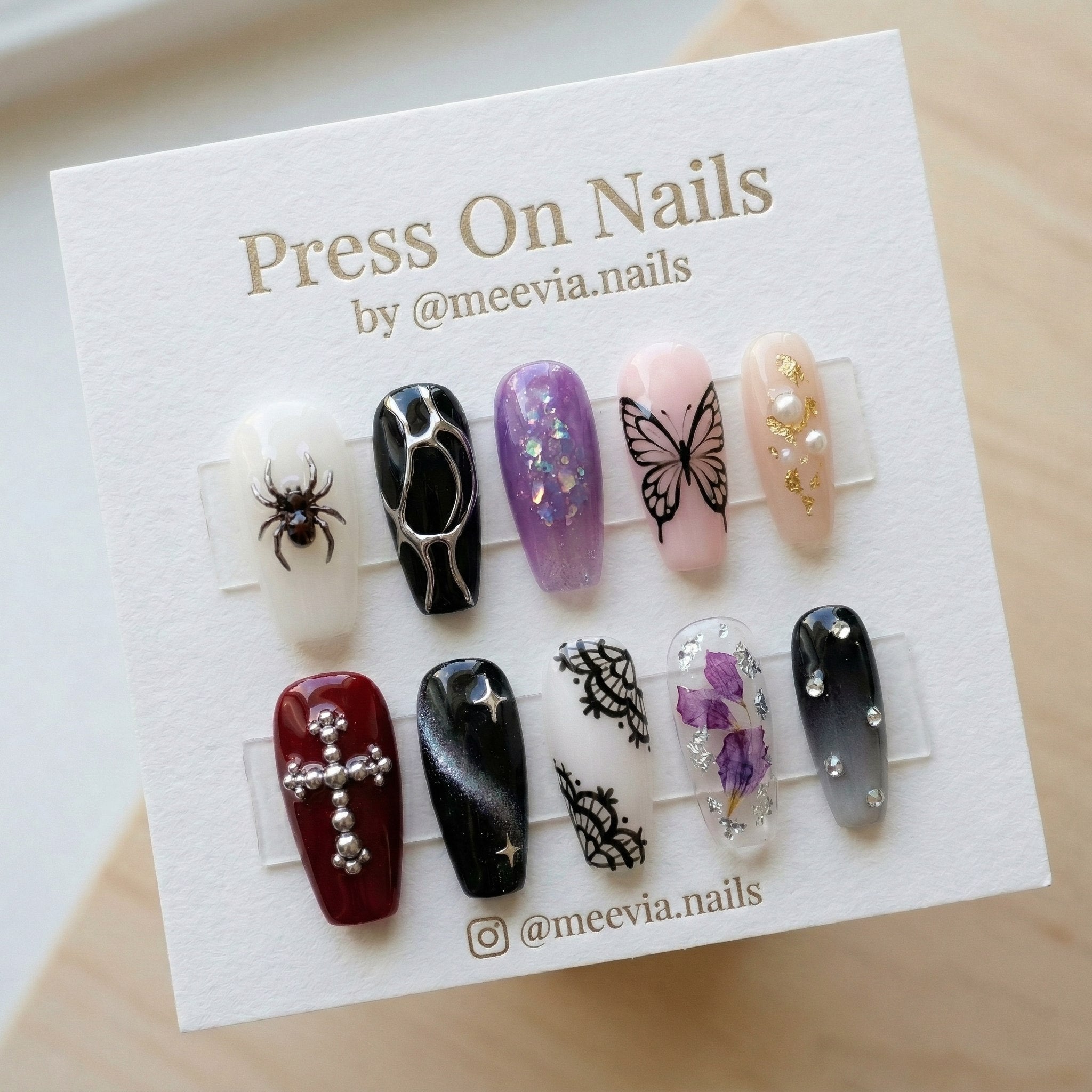 Long coffin-shaped gothic press-on nails with 3D spider and cross charms