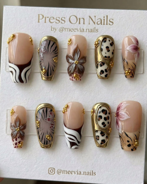 Long coffin-shaped press-on nail set with 3D floral art, metallic gold frames, and leopard animal print.