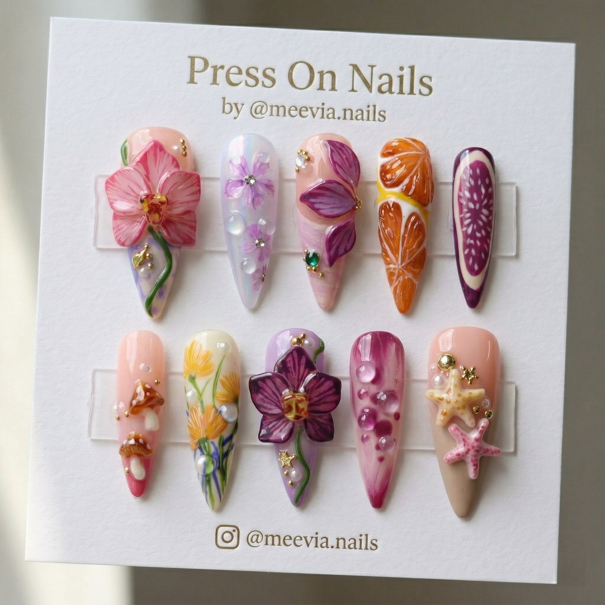 Stiletto-shaped press-on nail set with 3D tropical floral, citrus, and starfish nail art