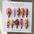 Stiletto-shaped press on nail set with 3D orchids, fruit slices, and botanical art