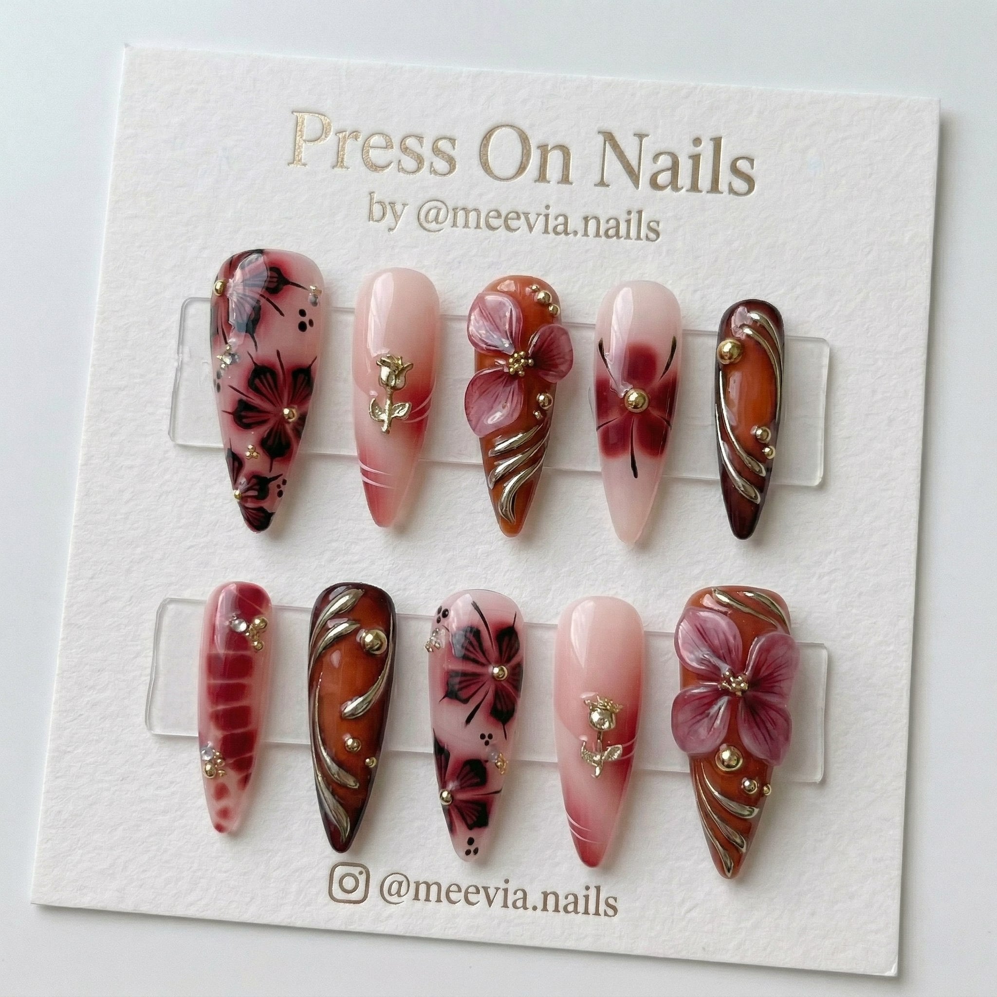 Stiletto-shaped red and amber press-on nail set with 3D floral art and gold rose charms