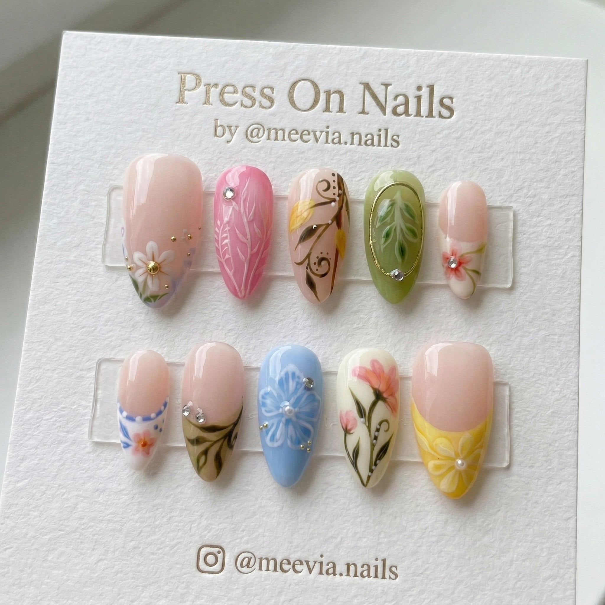 Almond-shaped press on nail set with colorful floral motifs and 3D embellishments