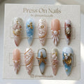 Almond-shaped silver chrome press-on nail set with a high-shine mirror finish