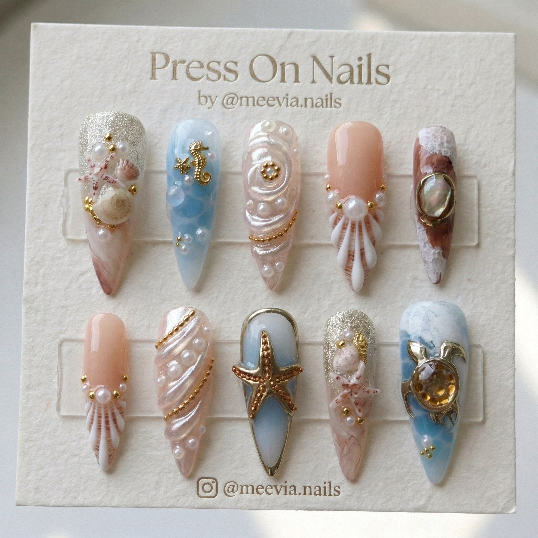 Almond-shaped silver chrome press-on nail set with a high-shine mirror finish