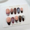 Almond-shaped press-on nail set with 3D burgundy flowers, tortoise shell patterns, and French tips.