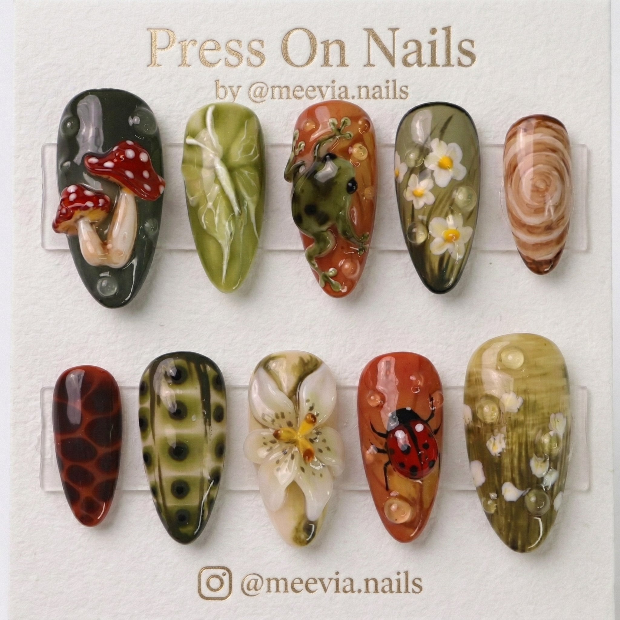 Almond-shaped nature-themed press-on nail set with 3D mushrooms, frog, and ladybug art
