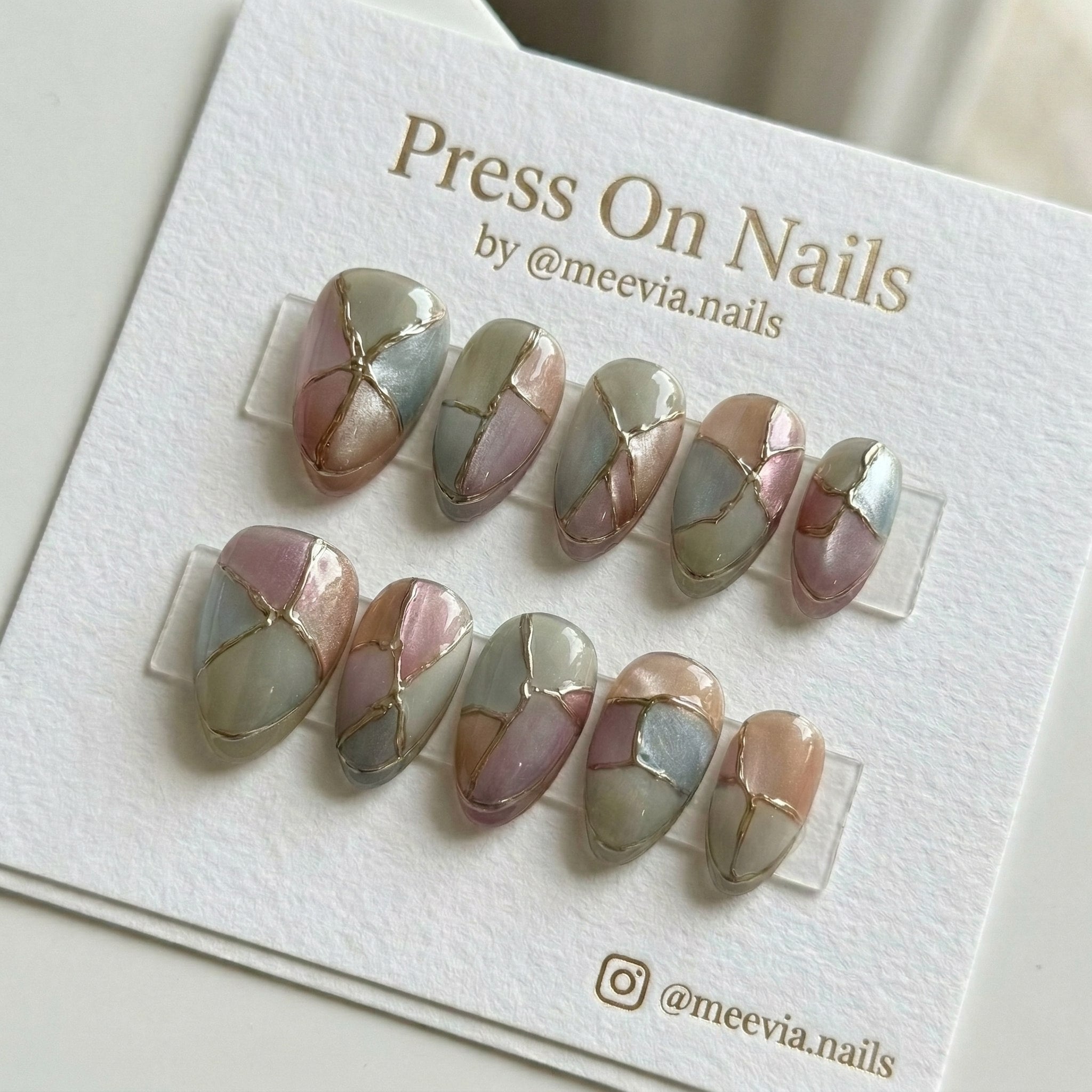 Almond-shaped press-on nail set with sage green and rose mosaic design and gold metallic 3D nail art