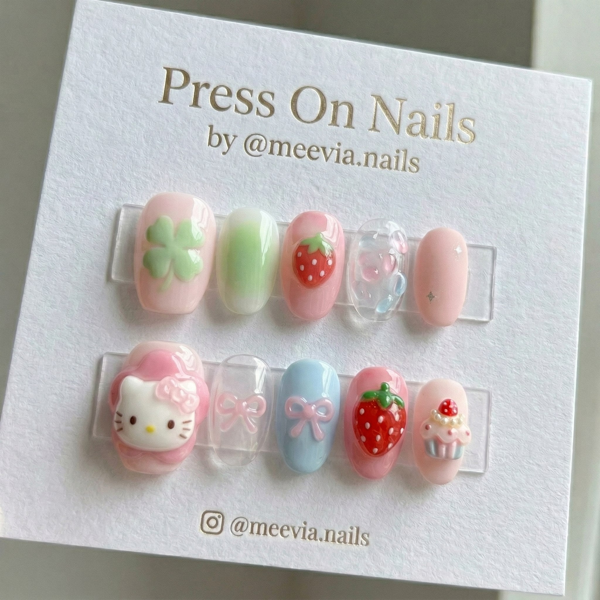 Short oval pink press-on nail set with 3D strawberry and Hello Kitty art